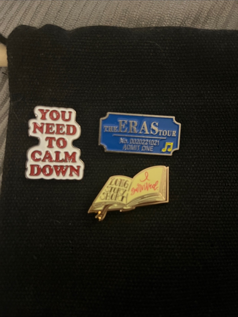 Taylor Swift Pin Set – You Need to Calm Down', and Yellow Open Book